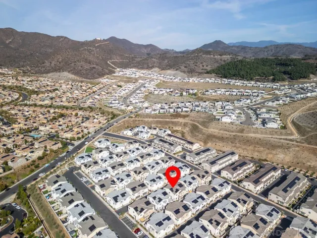an aerial view of residential house and sandy dunes