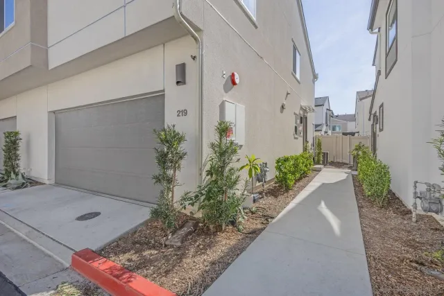 a vase with flowers sitting on a floor in front of a door