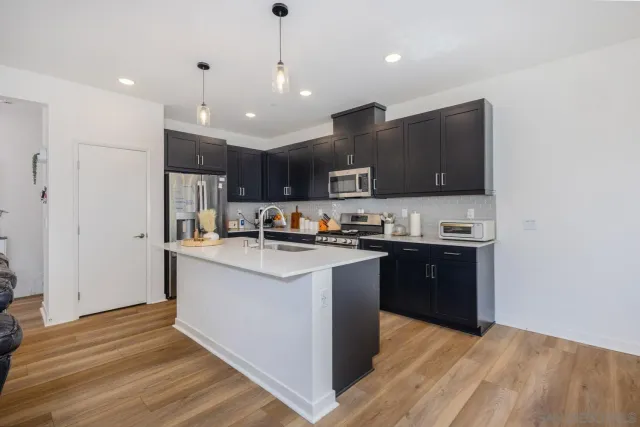 a kitchen with a sink a stove and refrigerator