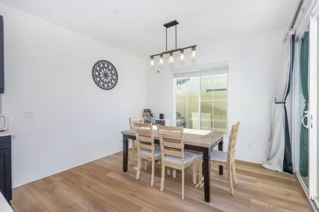 a living room with furniture a flat screen tv and a table