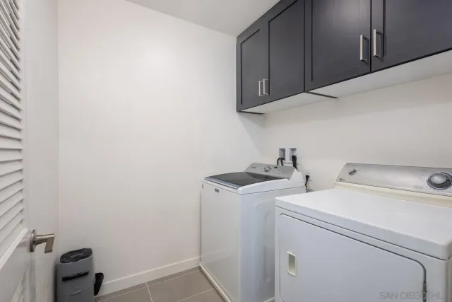 a spacious bedroom with a bed and a cabinets