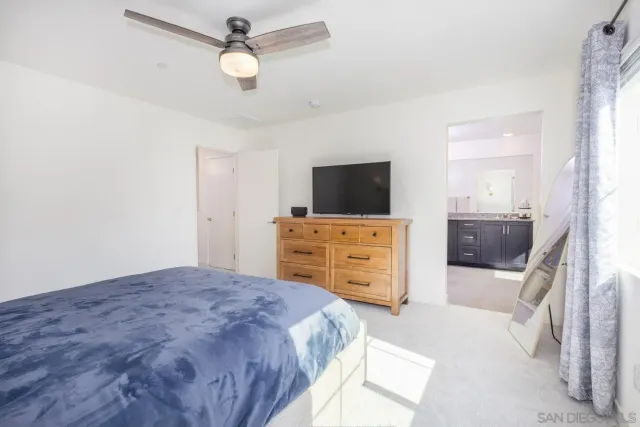a bathroom with a granite countertop sink mirror and toilet