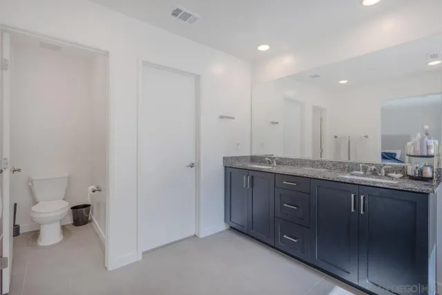 a spacious bathroom with a granite countertop tub shower sink and mirror