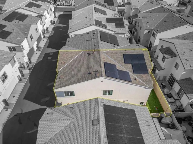 an aerial view of a house with a big yard