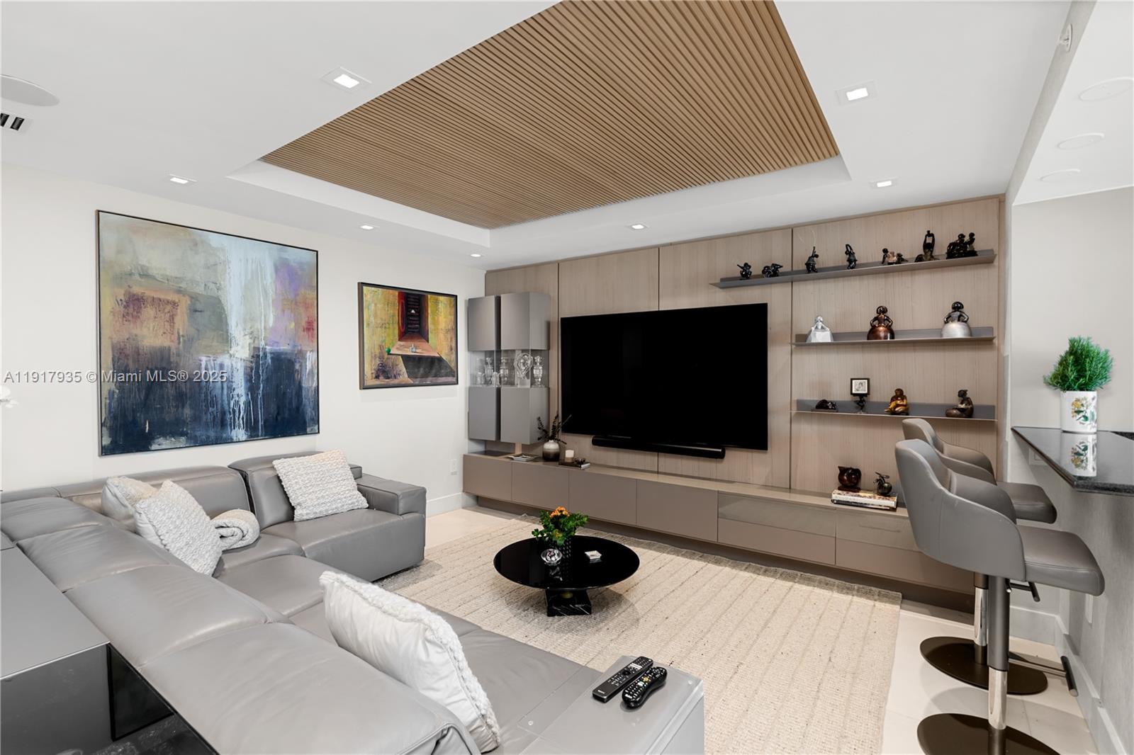 19955 Northeast 38th Court, Unit 1103 Aventura, FL 33180 - Photo 11 of 43 a living room with furniture and a flat screen tv