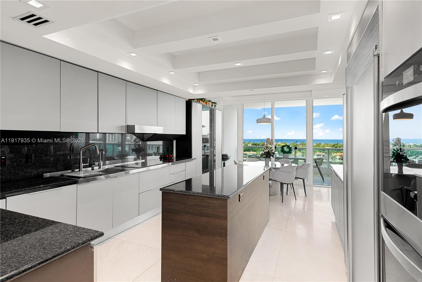19955 Northeast 38th Court, Unit 1103 Aventura, FL 33180 - Photo 13 of 43 a kitchen with a sink and a large window