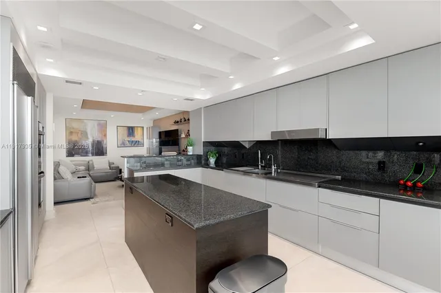 a kitchen with stainless steel appliances granite countertop a sink and a stove
