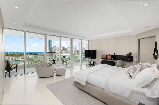 a bedroom with furniture and large windows