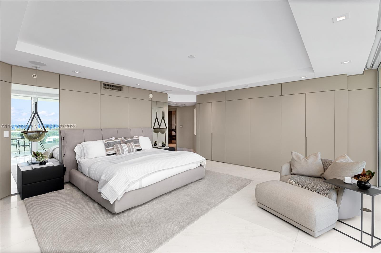 19955 Northeast 38th Court, Unit 1103 Aventura, FL 33180 - Photo 19 of 43 a spacious bedroom with a bed a couch and a potted plant