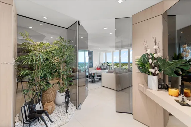 a living room with furniture and a potted plant