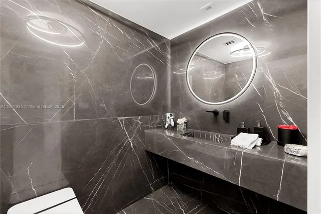 a bathroom with a sink mirror and vanity