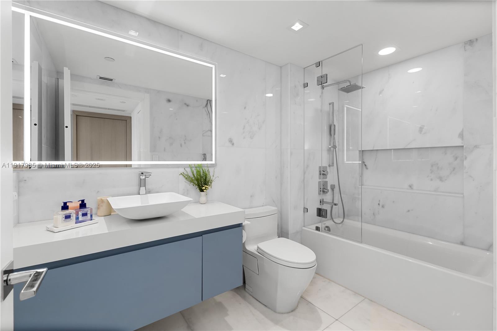 19955 Northeast 38th Court, Unit 1103 Aventura, FL 33180 - Photo 28 of 43 a bathroom with a sink a toilet and shower