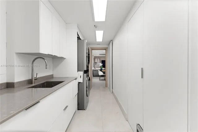 a kitchen with a sink and cabinets