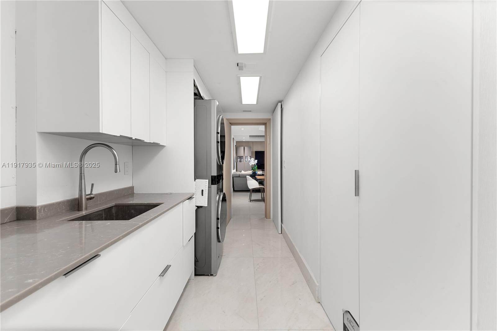 19955 Northeast 38th Court, Unit 1103 Aventura, FL 33180 - Photo 42 of 43 a kitchen with a sink and cabinets