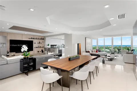 a kitchen with a table chairs stove and kitchen view