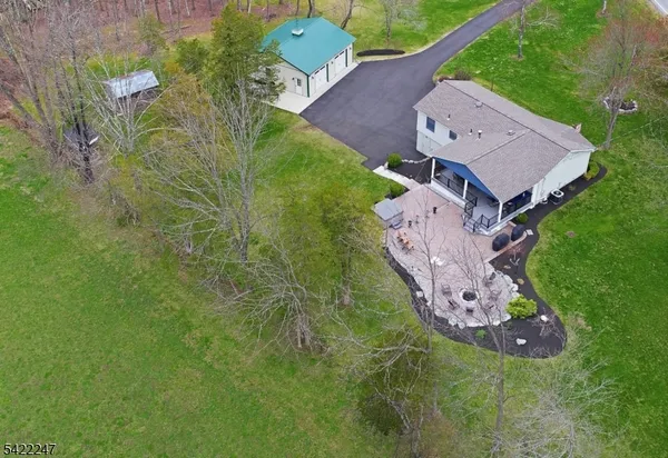 a view of a house with backyard and sitting area