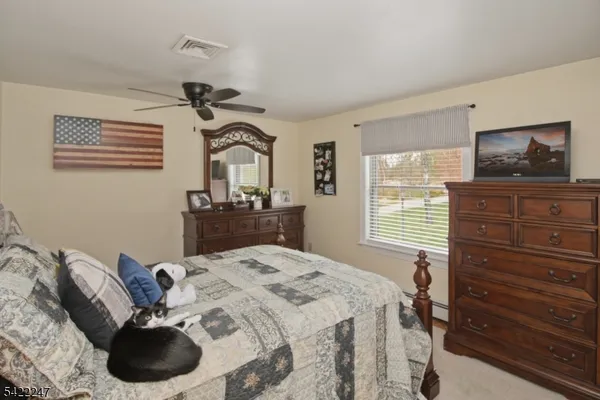 a bedroom with a bed and a television