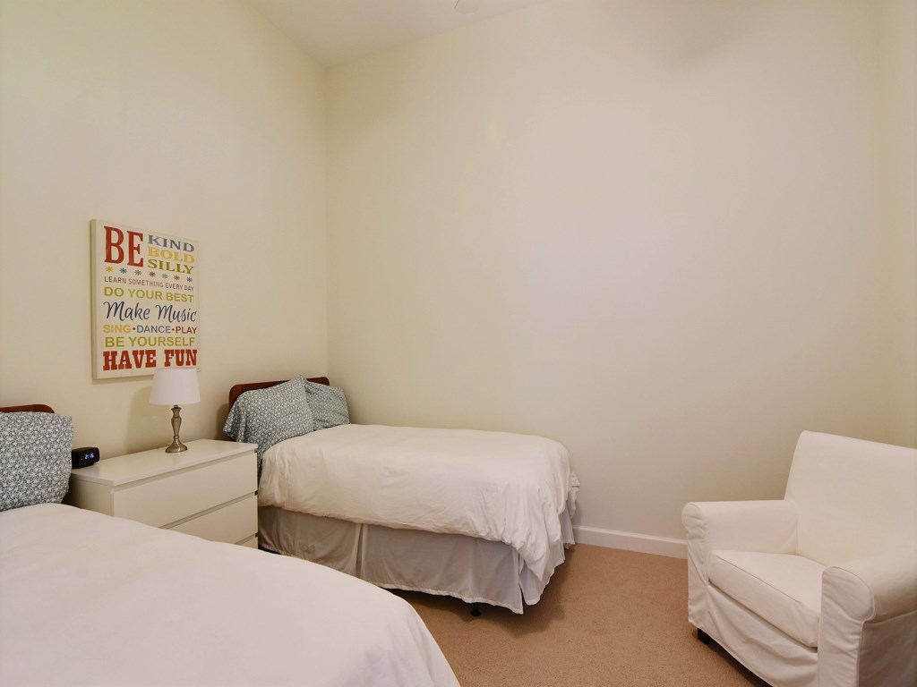 8785 Lakeside Boulevard Vero Beach, FL 32963 - Photo 17 of 36 a bedroom with two beds and a couch