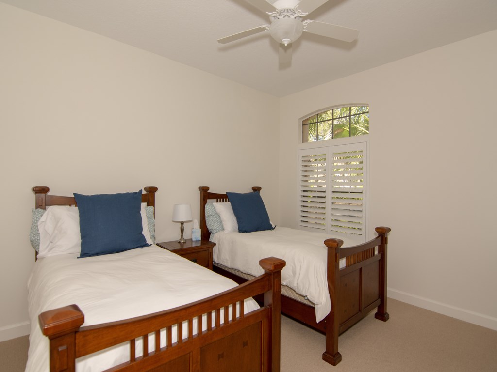 8785 Lakeside Boulevard Vero Beach, FL 32963 - Photo 18 of 36 a bedroom with furniture and a window