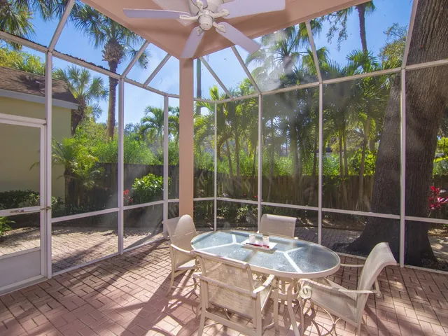 a patio with yard glass top table and chairs