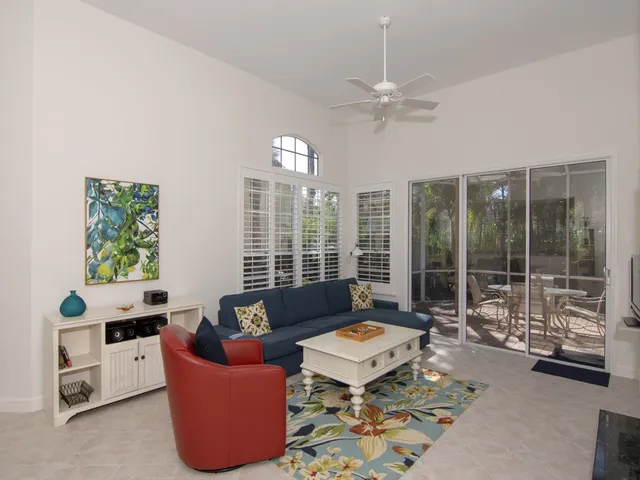 a living room with furniture and a floor to ceiling window