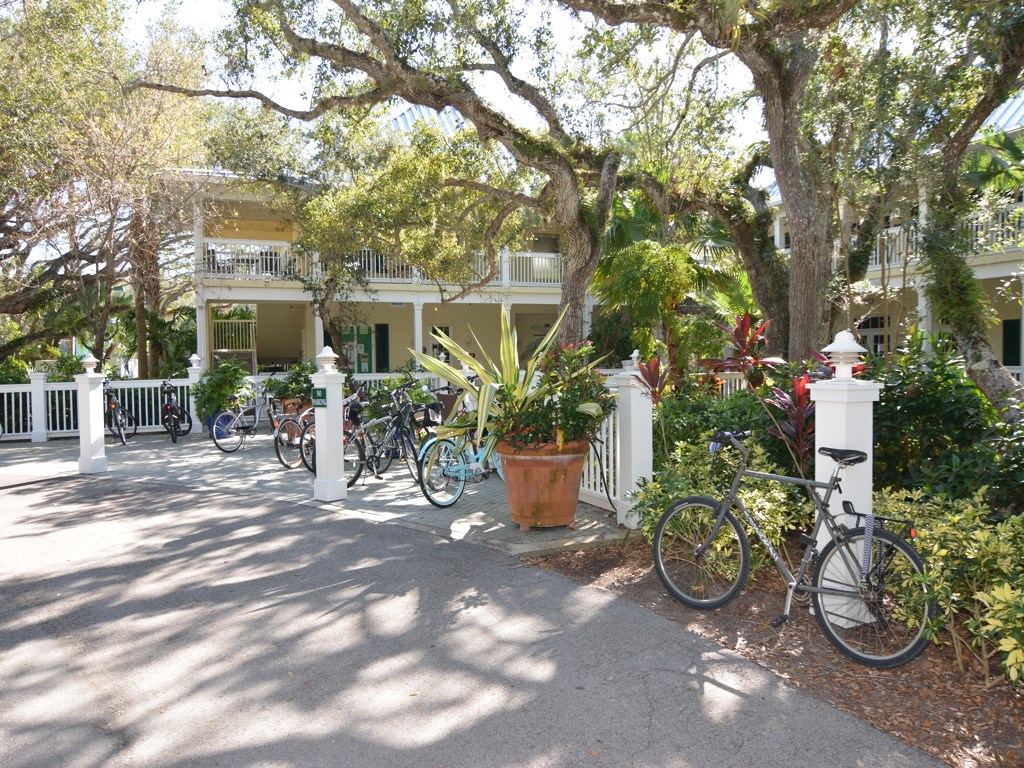 8785 Lakeside Boulevard Vero Beach, FL 32963 - Photo 28 of 36 a view of a patio with table and chairs potted plants and large tree
