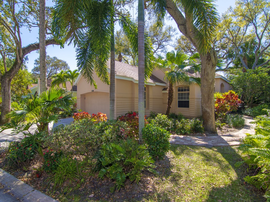 8785 Lakeside Boulevard Vero Beach, FL 32963 - Photo 29 of 36 a front view of a house with garden
