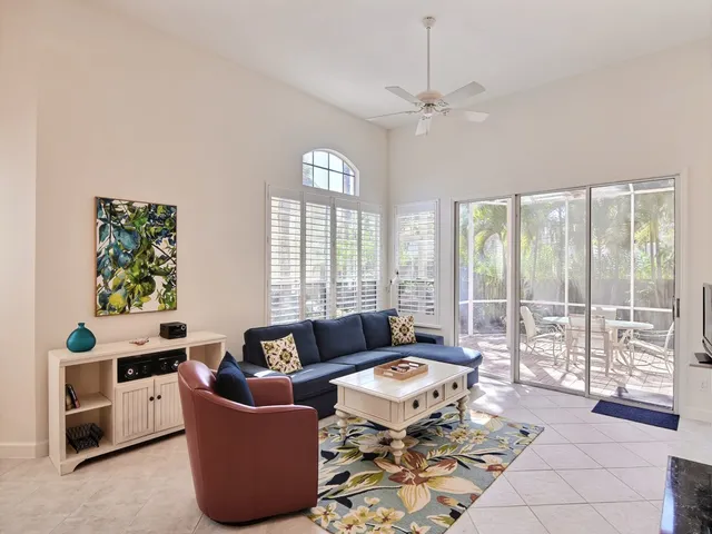 a living room with furniture and a floor to ceiling window