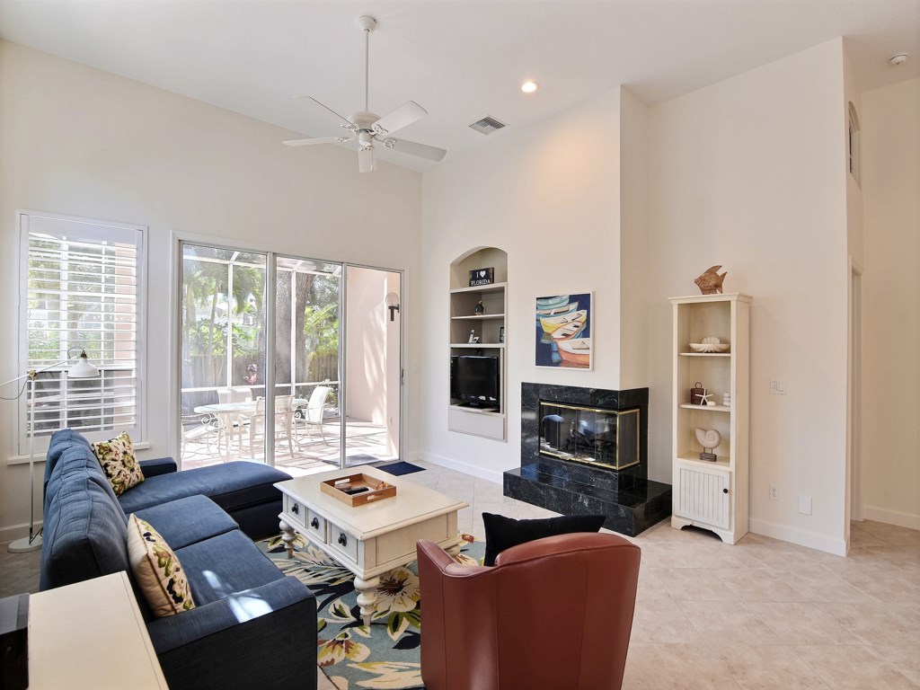 8785 Lakeside Boulevard Vero Beach, FL 32963 - Photo 4 of 36 a living room with furniture a large window and a fireplace