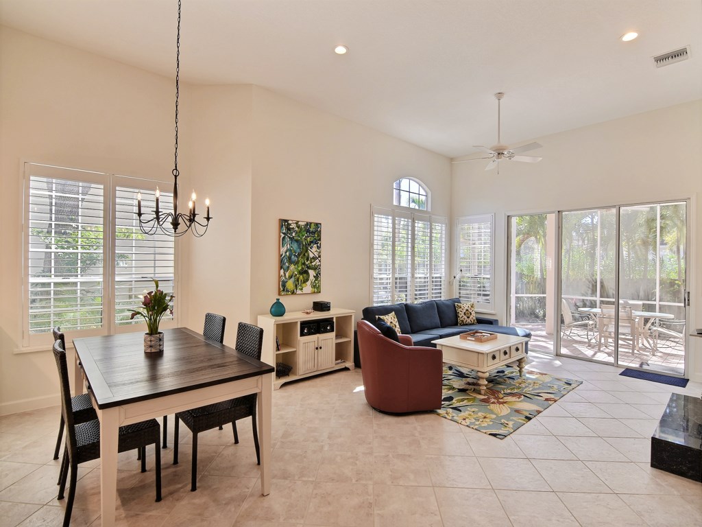 8785 Lakeside Boulevard Vero Beach, FL 32963 - Photo 5 of 36 a living room with furniture and large windows