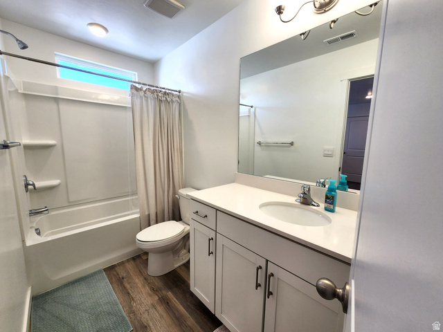 1736 East Fall Street Eagle Mountain, UT 84005 - Photo 11 of 30 Full bath featuring vanity, dark wood-type flooring, and shower / tub combo with curtain
