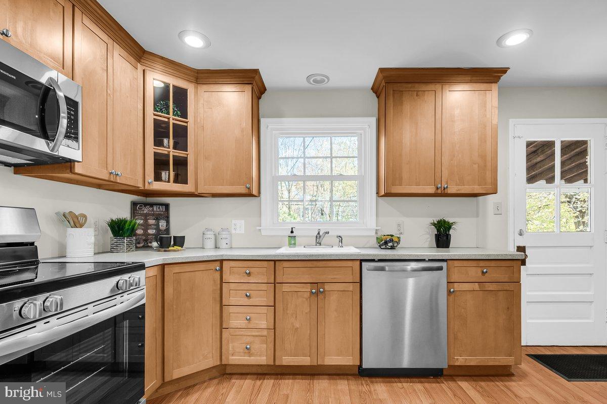 250 Potomac Road Wilmington, DE 19803 - Photo 13 of 26 a kitchen with stainless steel appliances granite countertop a sink a stove and a microwave