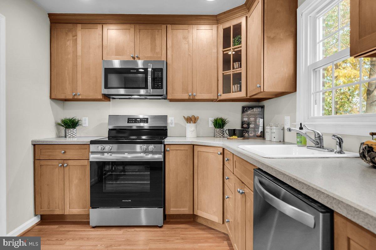 250 Potomac Road Wilmington, DE 19803 - Photo 14 of 26 a kitchen with stainless steel appliances granite countertop a sink stove and microwave
