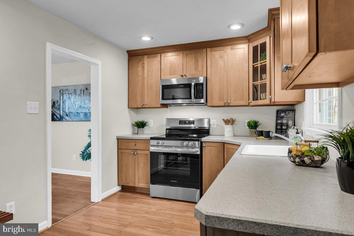 250 Potomac Road Wilmington, DE 19803 - Photo 15 of 26 a kitchen with stainless steel appliances granite countertop a stove a sink and a microwave
