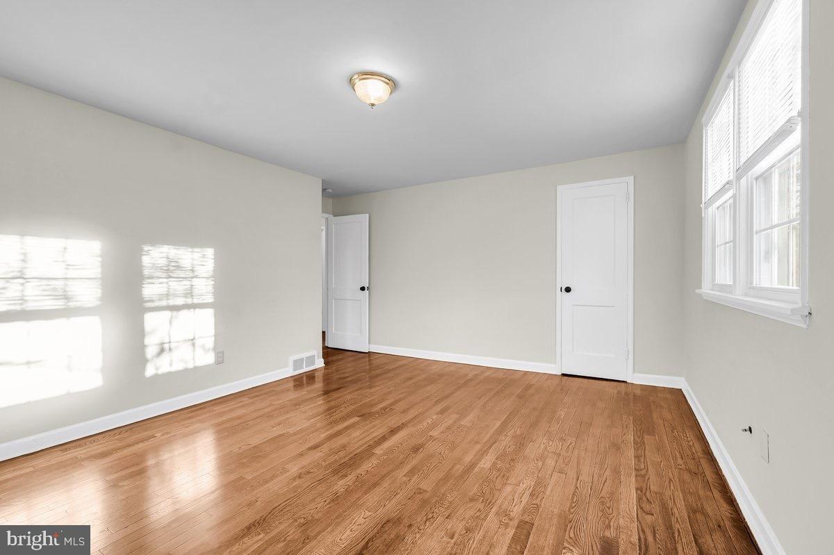 250 Potomac Road Wilmington, DE 19803 - Photo 19 of 26 an empty room with wooden floor and windows