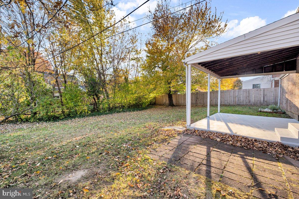 250 Potomac Road Wilmington, DE 19803 - Photo 24 of 26 a view of a backyard with table and chairs under an umbrella