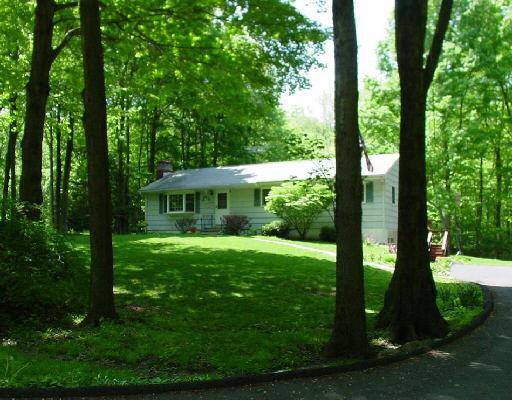 27 White Birch Road Redding, CT 06896 - Photo 1 of 1 a view of a house with backyard sitting area and garden