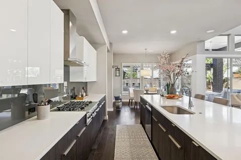 a large kitchen with stainless steel appliances a lot of counter space and a sink