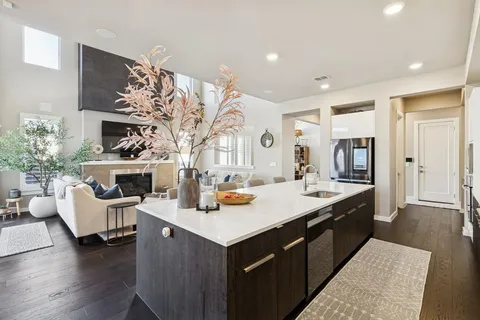 a kitchen with a sink stove and cabinets