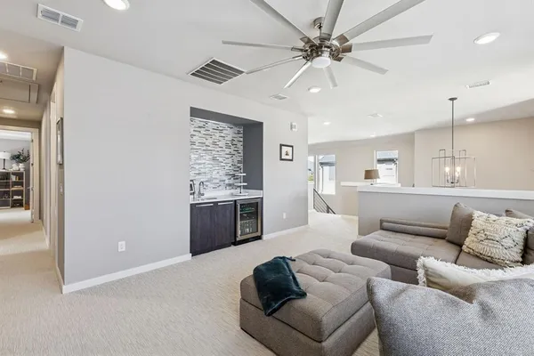 a living room with furniture and kitchen view