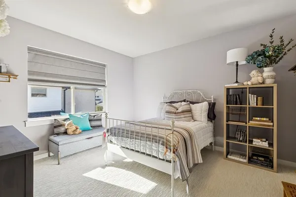 a bedroom with a bed and a couch