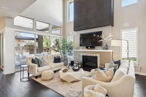 a living room with furniture a fireplace and a flat screen tv