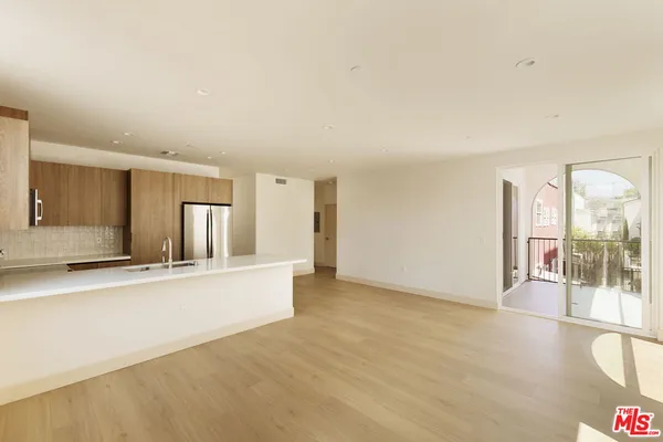 a view of a kitchen with a sink and a window