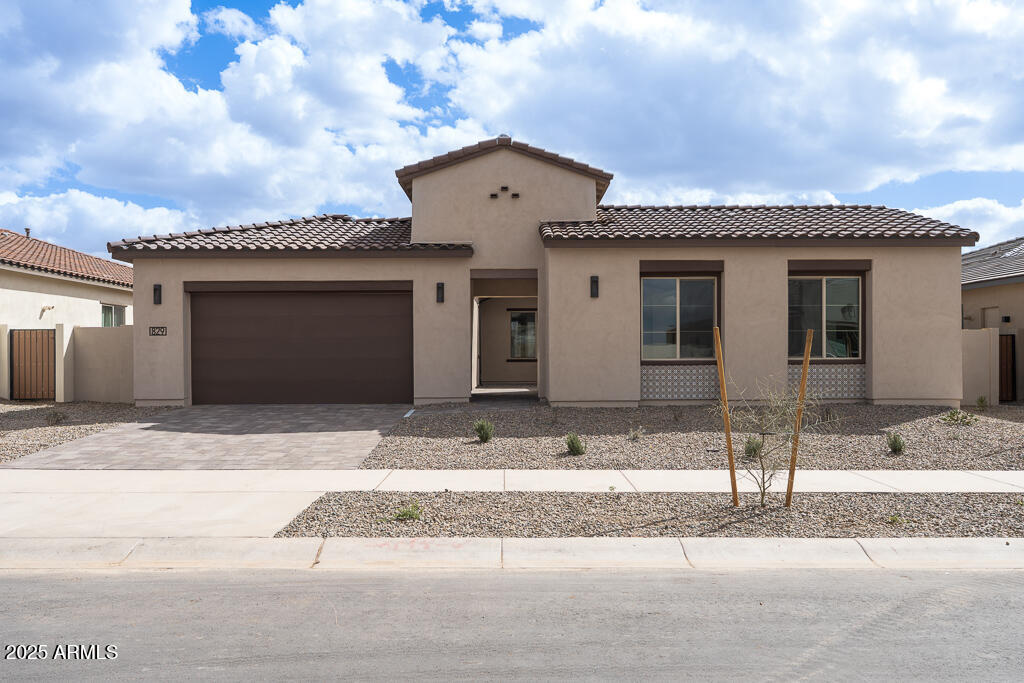 829 Golden Ore Pass Apache Junction, AZ 85120 - Photo 1 of 33 a front view of a house with a garden