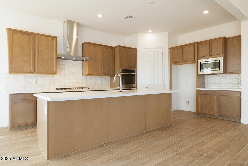 829 Golden Ore Pass Apache Junction, AZ 85120 - Photo 2 of 33 a kitchen with stainless steel appliances granite countertop a refrigerator and a stove top oven