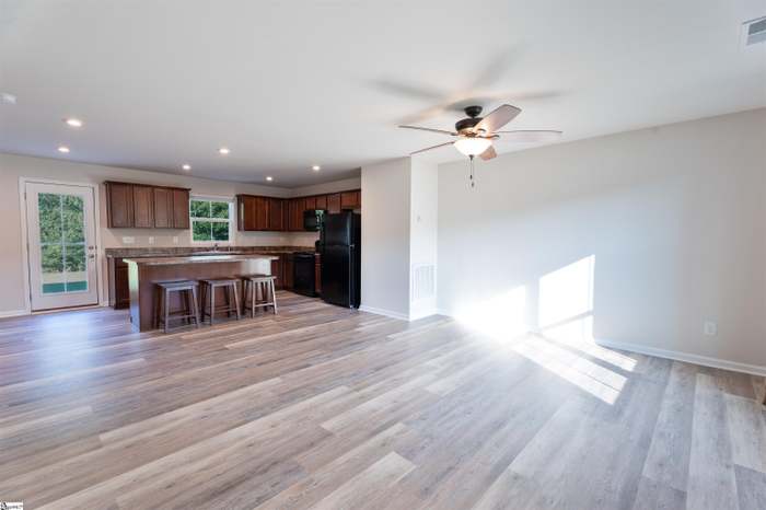 156 Queens Mill Court Pendleton, SC 29670 - Photo 3 of 18 This bright, open-concept living space features durable flooring and a functional kitchen island.