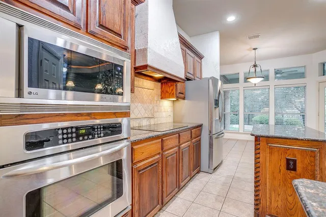 a bedroom with a bed chandelier and a window