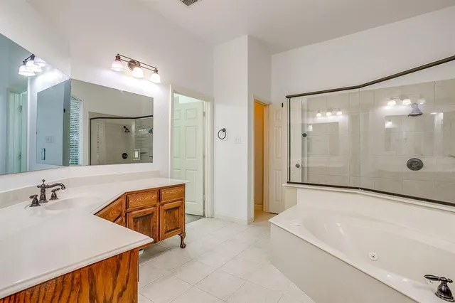 a bathroom with a tub sink and mirror