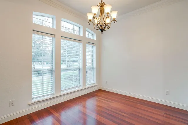 a view of a livingroom with a large window wooden floor and front door