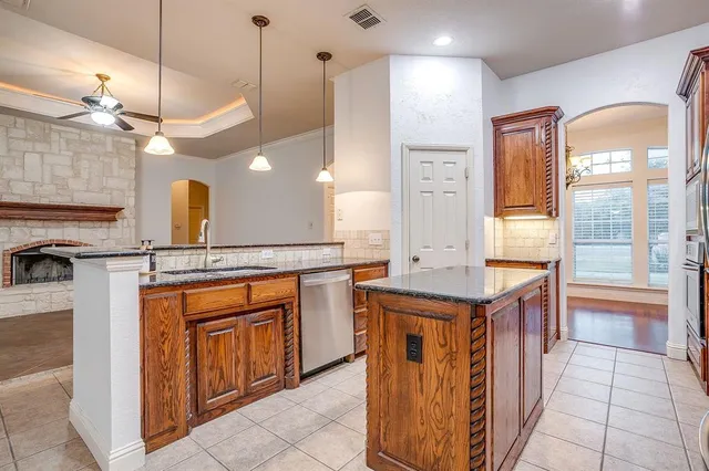 a kitchen with stainless steel appliances granite countertop a stove and a sink